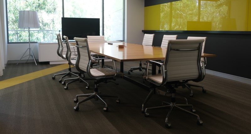 empty boardroom with chairs pushed in