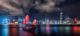 hong kong skyline night time with junk boat