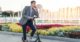 man in suit on e scooter speaking on phone