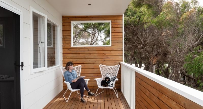 augusta-boat-house-dog-woman-balcony-deck-feature