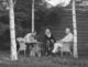 Jennifer Macquarie and family sitting in backyard black and white