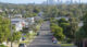 Residential houses street against Brisbane City skyline