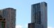 Modern residential apartment towers in Sydney against a clear blue sky