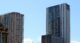 Modern residential apartment towers in Sydney against a clear blue sky