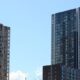 Modern residential apartment towers in Sydney against a clear blue sky