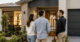 An Australian couple talking with a home builder in front of their new home