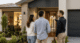 An Australian couple talking with a home builder in front of their new home