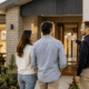 An Australian couple talking with a home builder in front of their new home